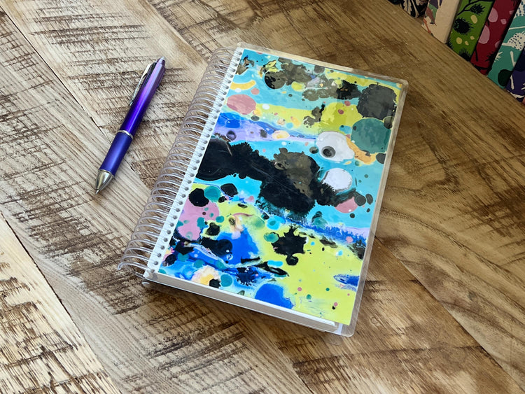 a wooden table topped with lots of craft supplies